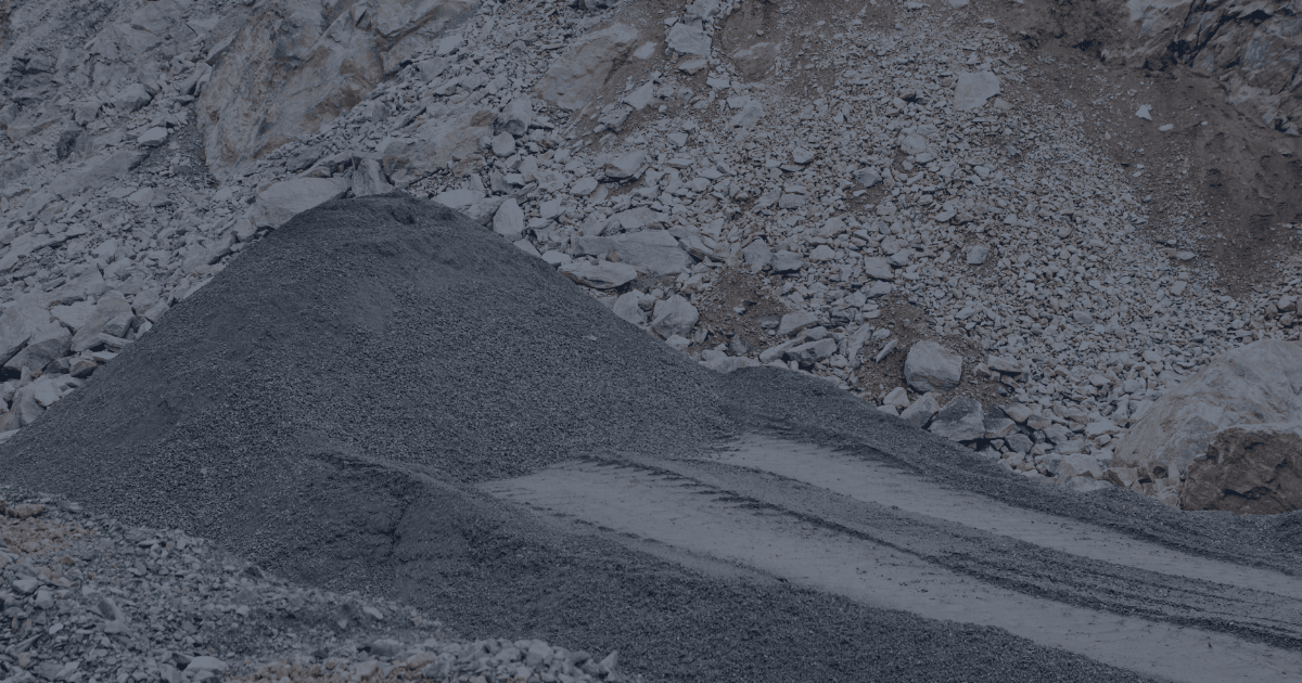 Stockpile of crushed ore at an open-pit mining site, illustrating the potential for misclassification and material loss without proper tracking systems.