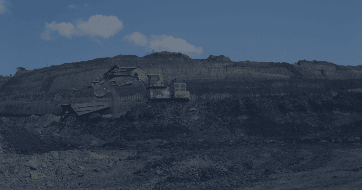 Excavator loading ore into a haul truck in an open-pit mining operation, illustrating the risk of misrouted material and stockpile misallocation.